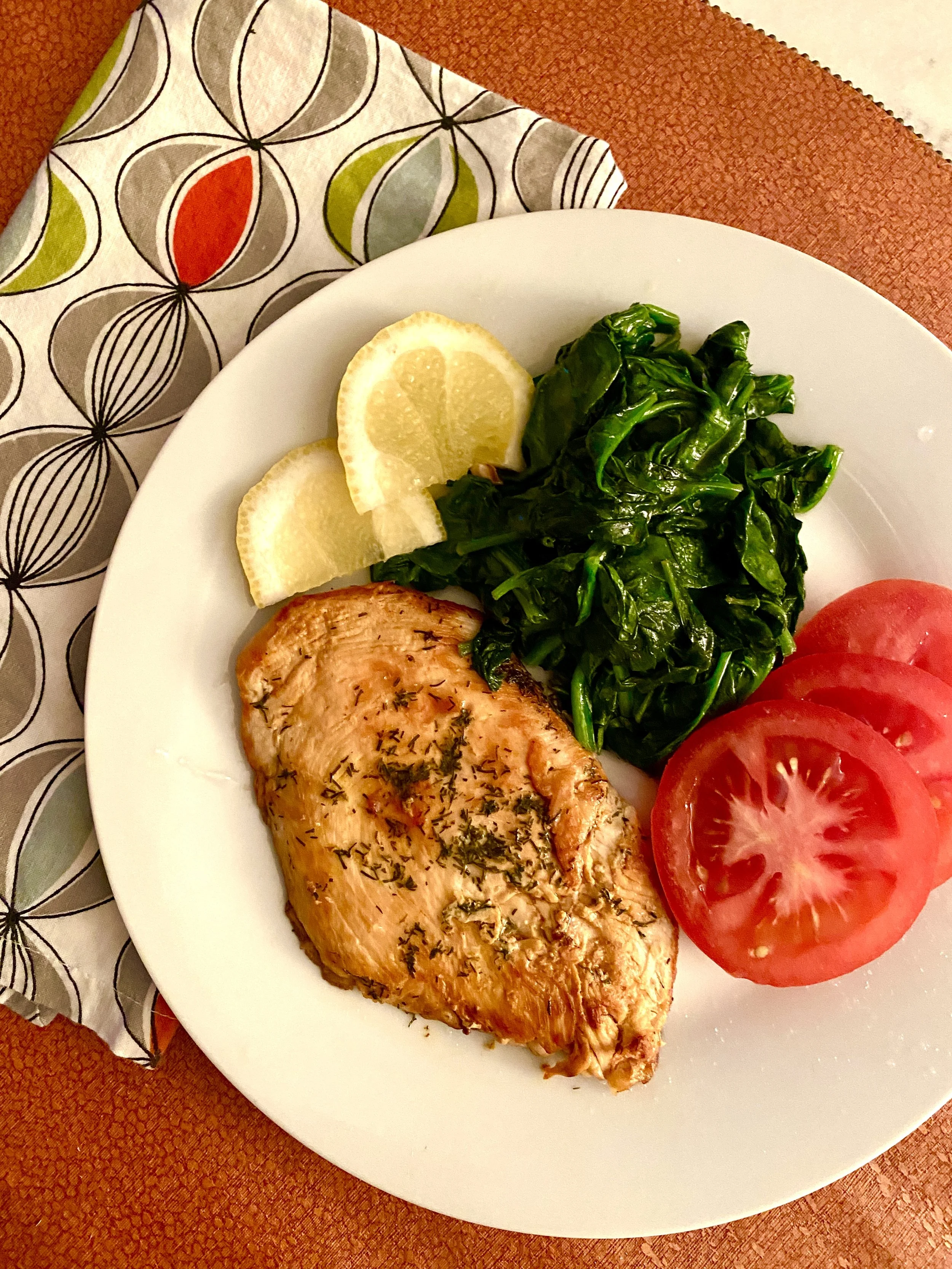 Anti-inflammatory plate of chicken, spinach, and tomatoes supporting a bronchiectasis-friendly diet
