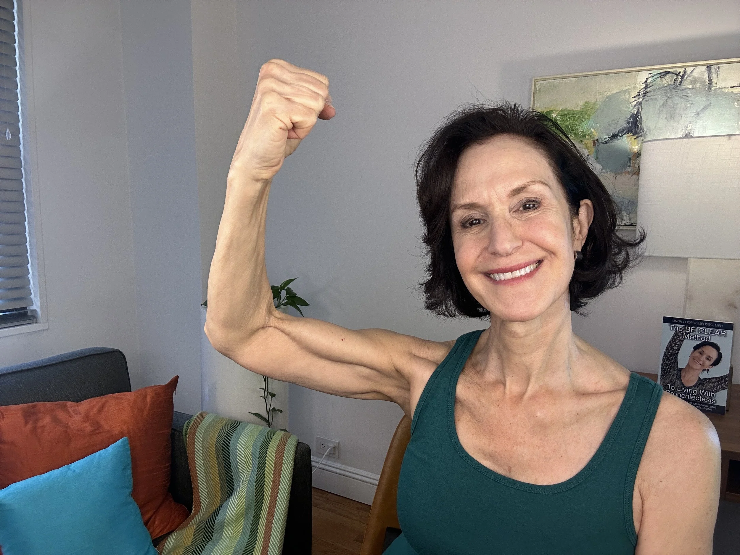 Linda Esposito, personal trainer and health coach, showing her muscles