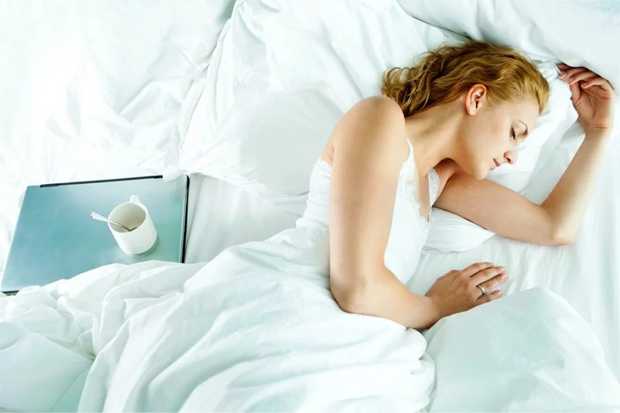 Woman sleeping peacefully in bed, supporting restorative sleep with bronchiectasis