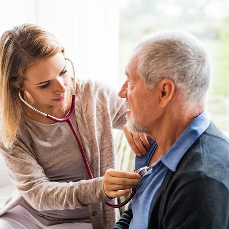 female doctor listening to male patient's lungs