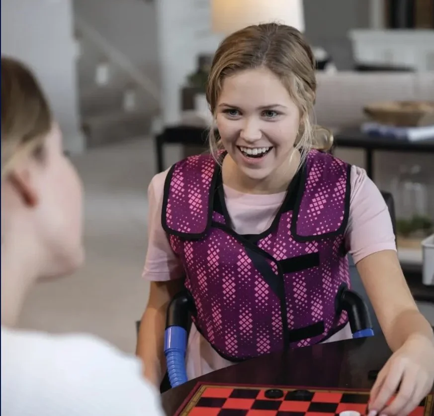 Young woman wearing HFCWO vest and smiling
