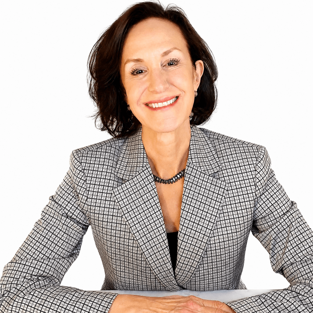 Linda Esposito, bronchiectasis & NTM Lung Disease navigator with arms folded on table smiling
