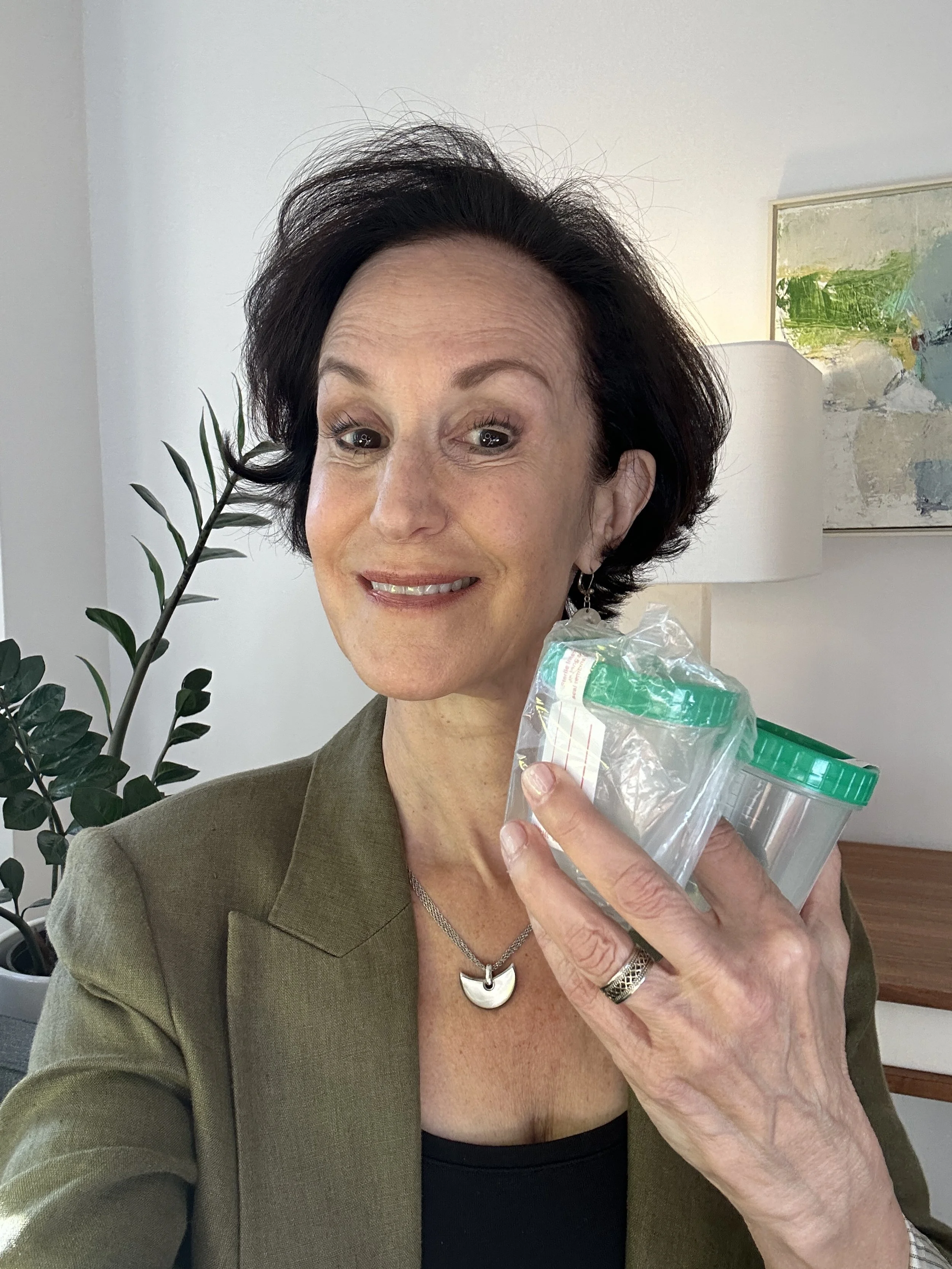 Linda Esposito, bronchiectasis and NTM Lung Disease health coach holding three sputum cups