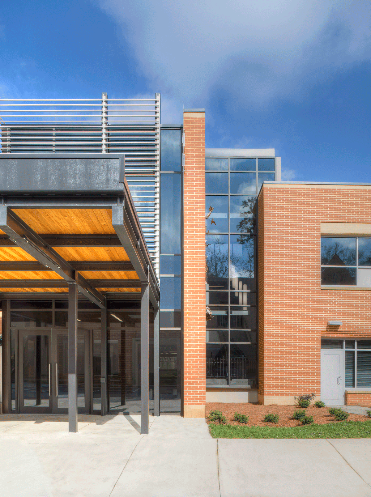 K-8 school entrance with brick and glass exterior