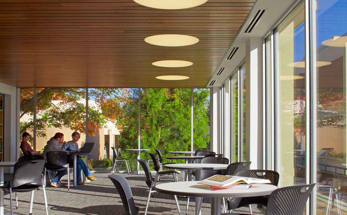 Student flex space with study tables and large windows