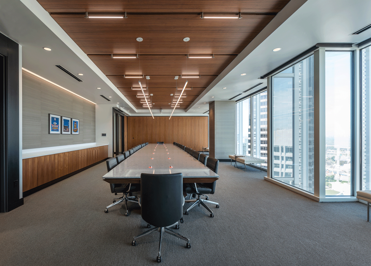 Modern and sleek boardroom with walnut clad side paneling and views of the Atlanta downtown and skyline