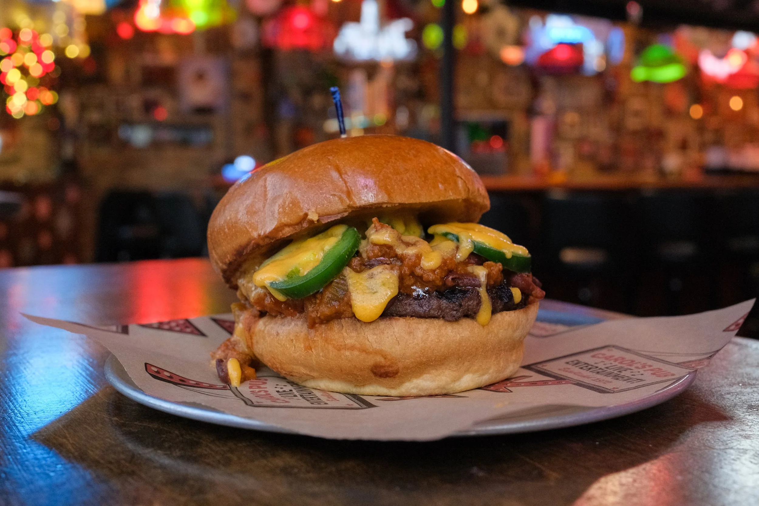 Food and beverage photography of a plated burger in a neighborhood bar, created for restaurant and hospitality marketing