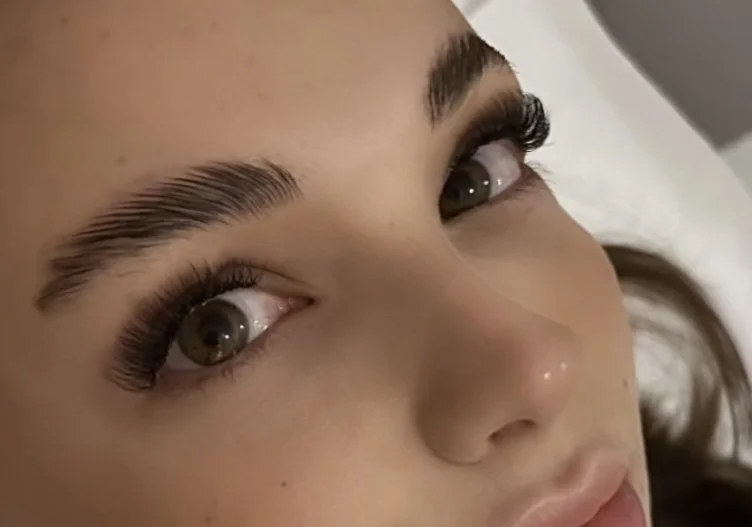 Close-up of a woman's face focusing on her eyes and eyebrows.