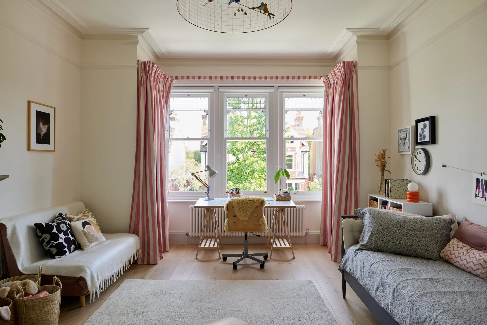 A children’s bedroom designed with a warm neutral backdrop and playful accents. The colourful yet subtle decor create a timeless setting that evolves with the child’s changing interests and hobbies.