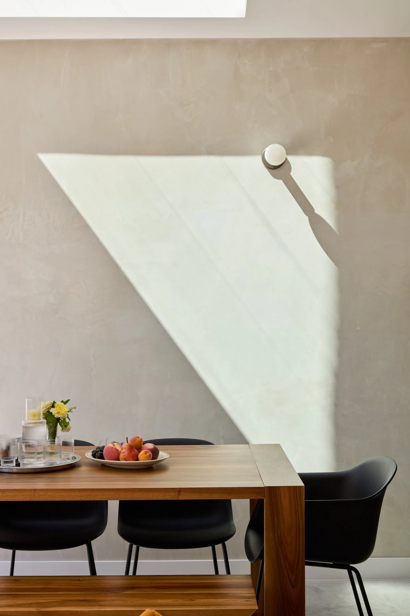 Cool grey plaster wall and polished concrete floors