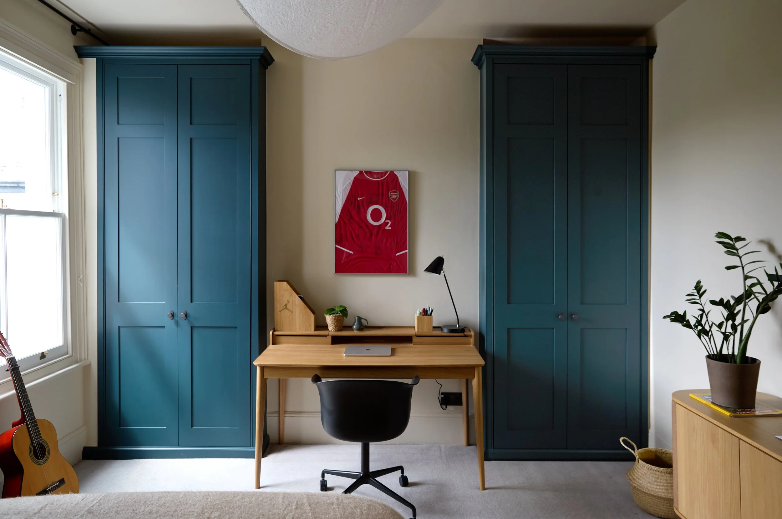 A calm and timeless scheme designed to evolve with its occupant, balancing practicality with subtle references to personal interests.