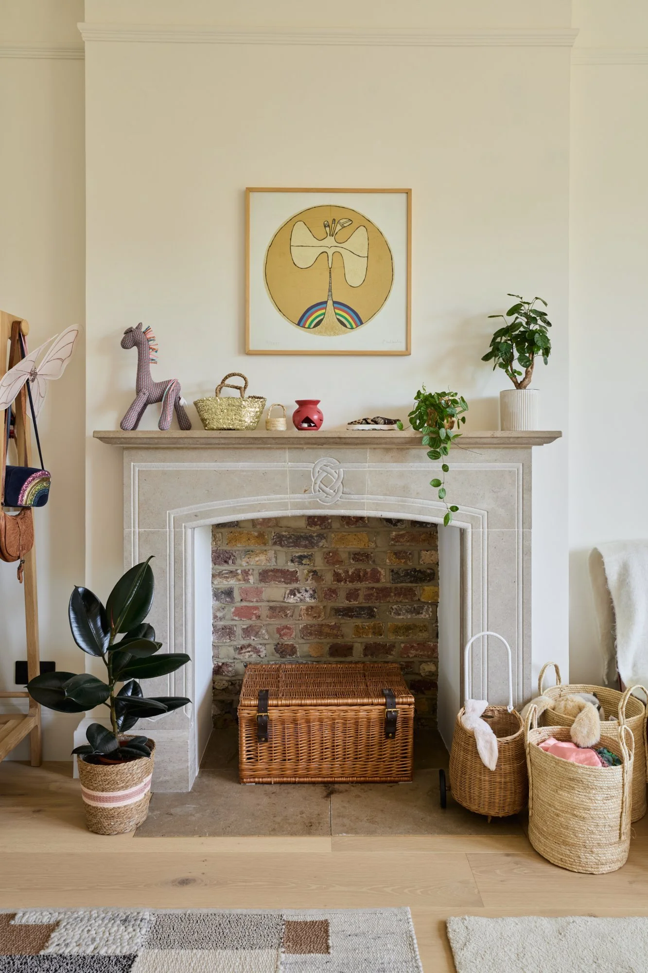 A children’s bedroom designed with a warm neutral backdrop and playful accents. The stone fireplace, exposed brick, and colourful decor create a timeless setting that evolves with the child’s changing interests and hobbies.
