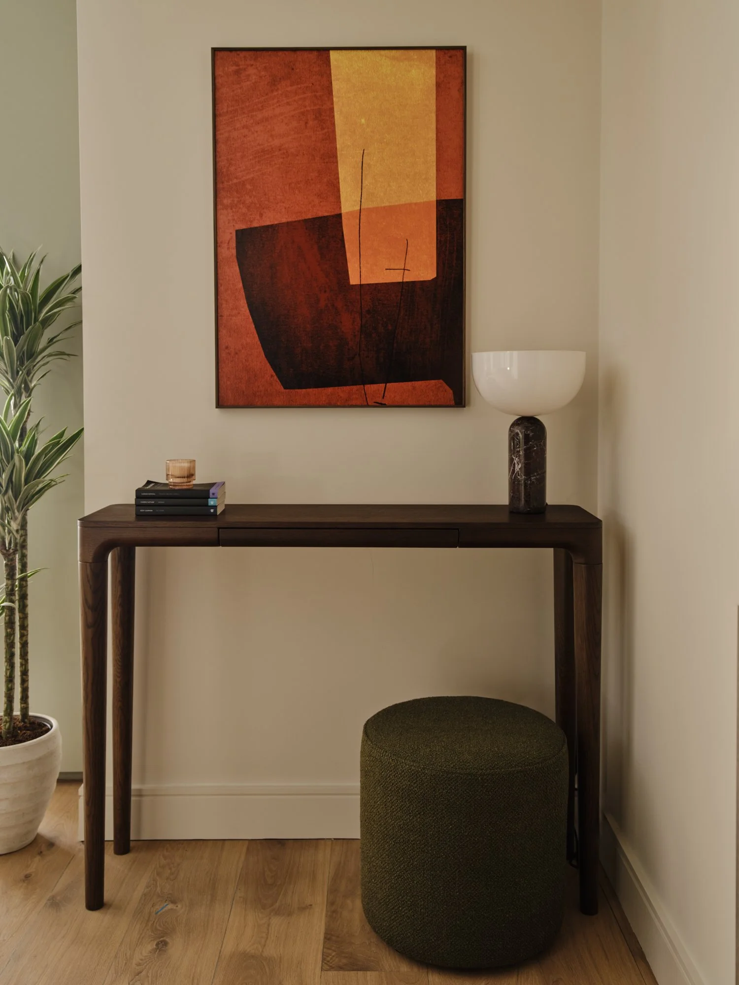 Minimalist console table with sculptural lighting and abstract artwork in a calm, contemporary West London interior.
