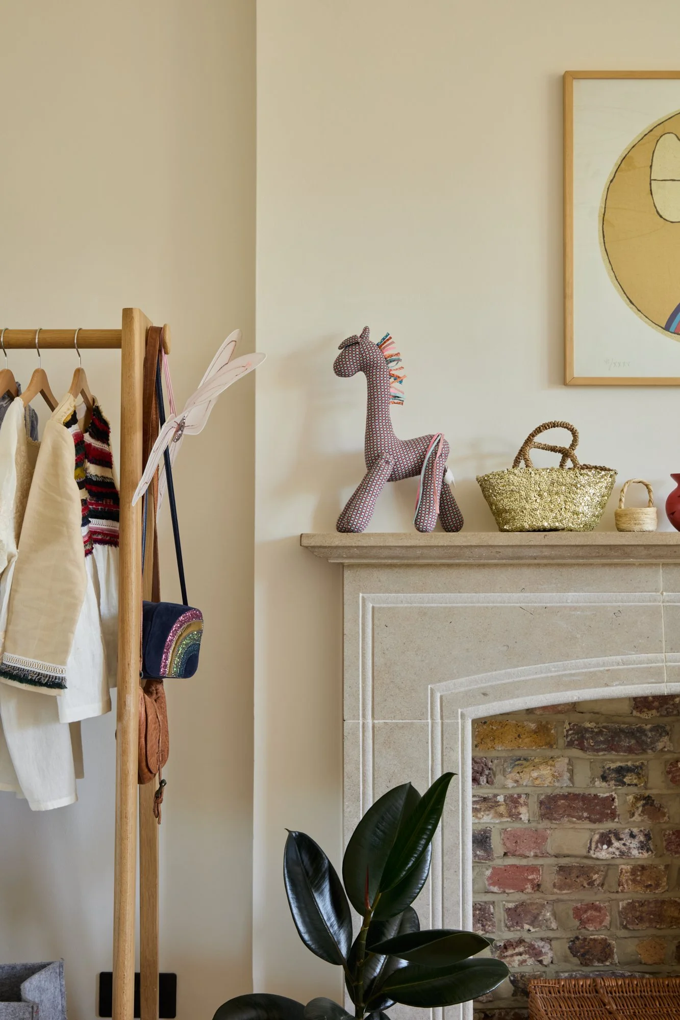 A children’s bedroom designed with a warm neutral backdrop and playful accents. The stone fireplace, exposed brick, and colourful decor create a timeless setting that evolves with the child’s changing interests and hobbies.