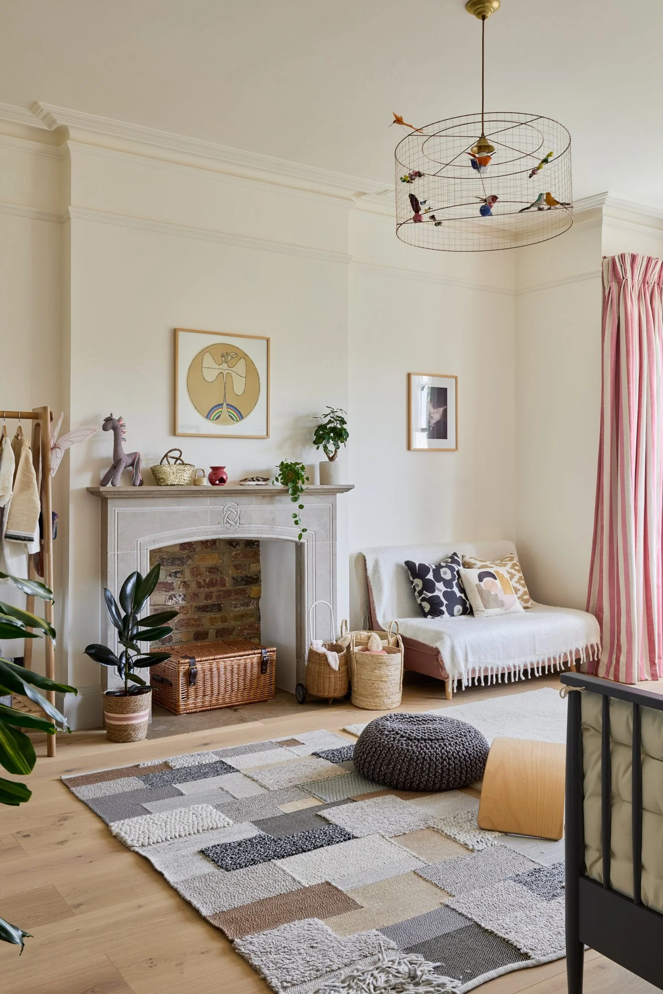 A children’s bedroom designed with a warm neutral backdrop and playful accents. The stone fireplace, exposed brick, and colourful decor create a timeless setting that evolves with the child’s changing interests and hobbies.