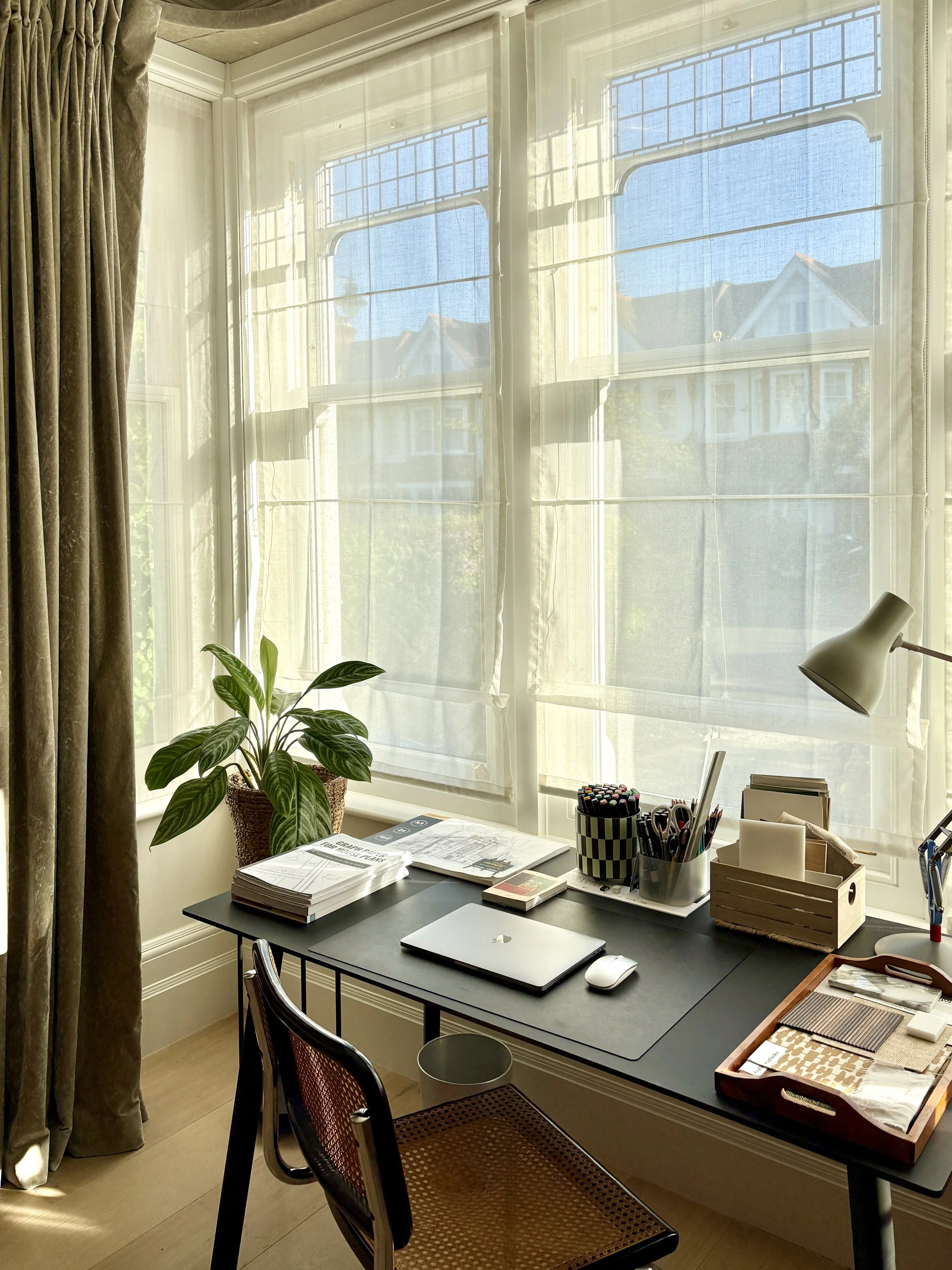 Multifunctional Edwardian reception room with an office corner with views to the outdoors.