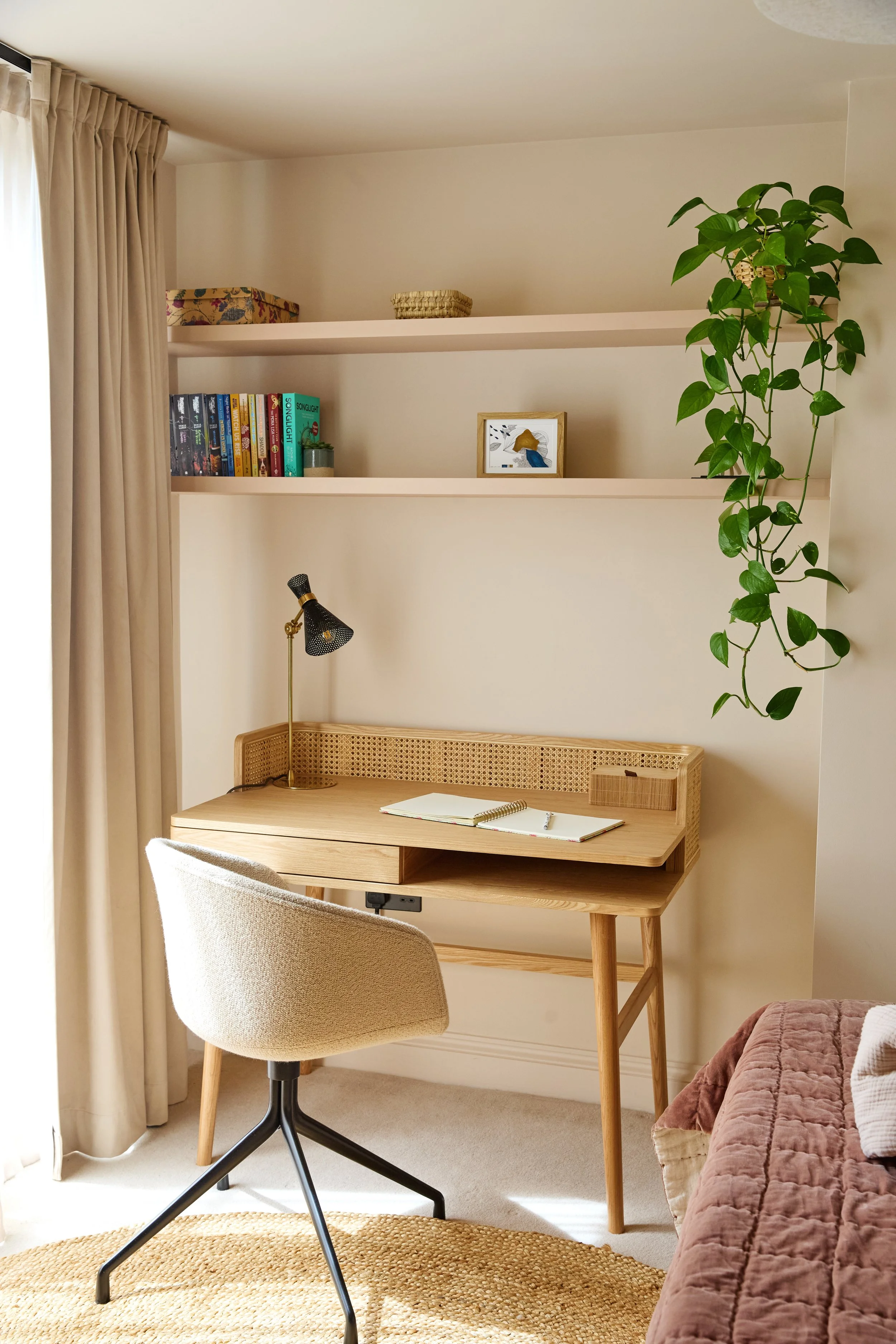 Bright study corner with beautiful views for the teenager girl bedroom, with bespoke shelves and rattan desk.