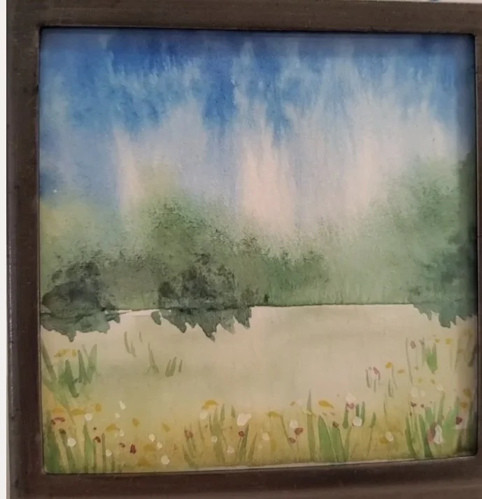 Watercolor painting of a landscape with a blue sky, green trees, and a yellow field with flowers.
