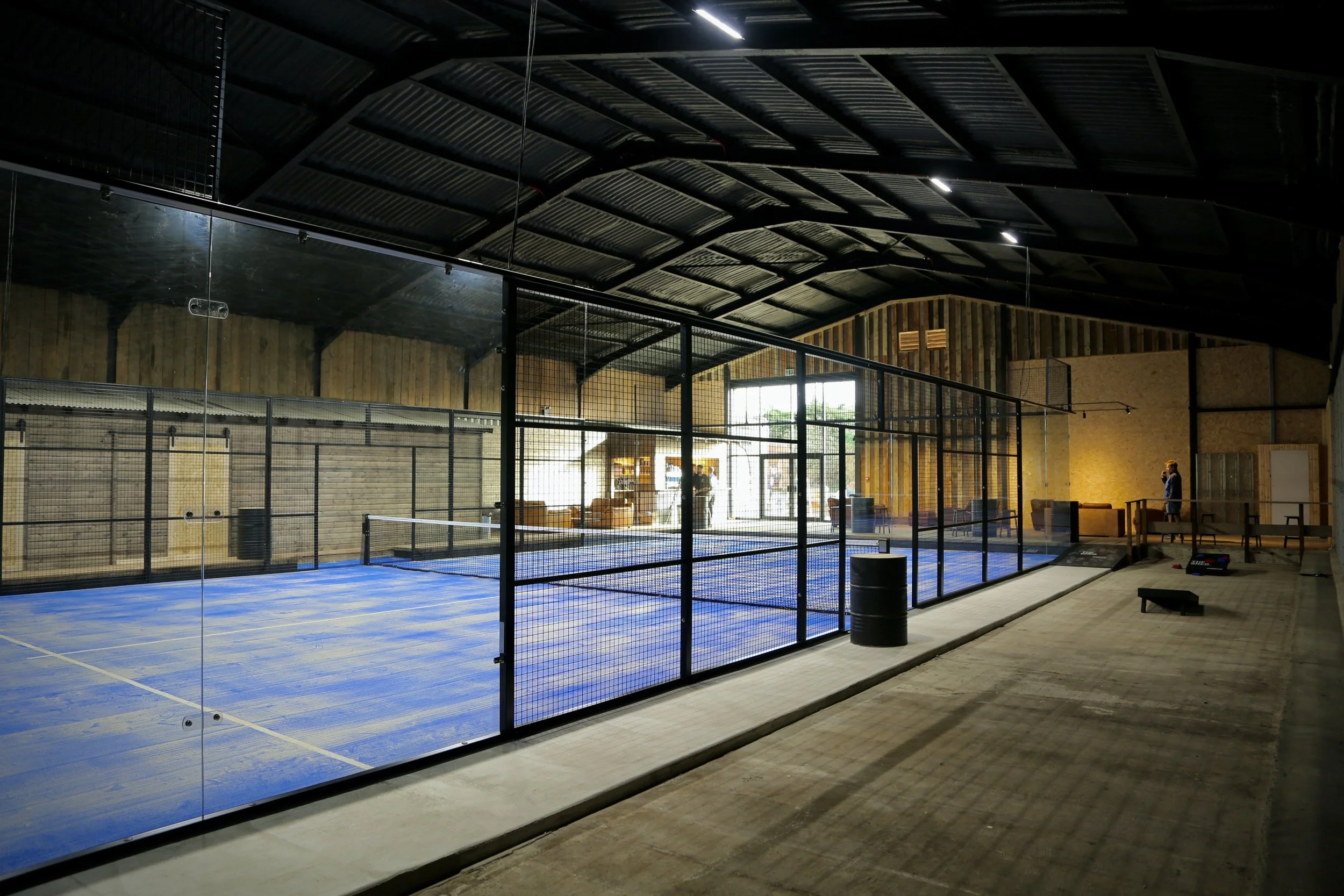 a picture of the blue padel court inside of the shed