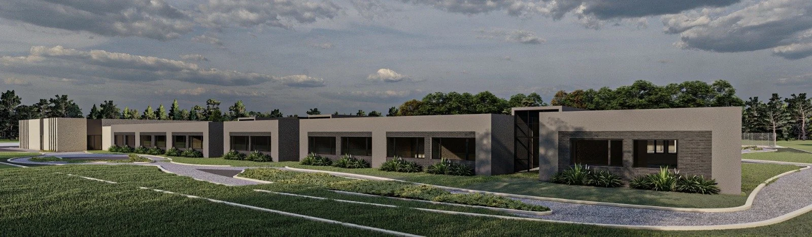 Vista panorámica de un conjunto de casas modernas con jardines y caminos pavimentados, en un entorno natural con árboles y cielo nublado.