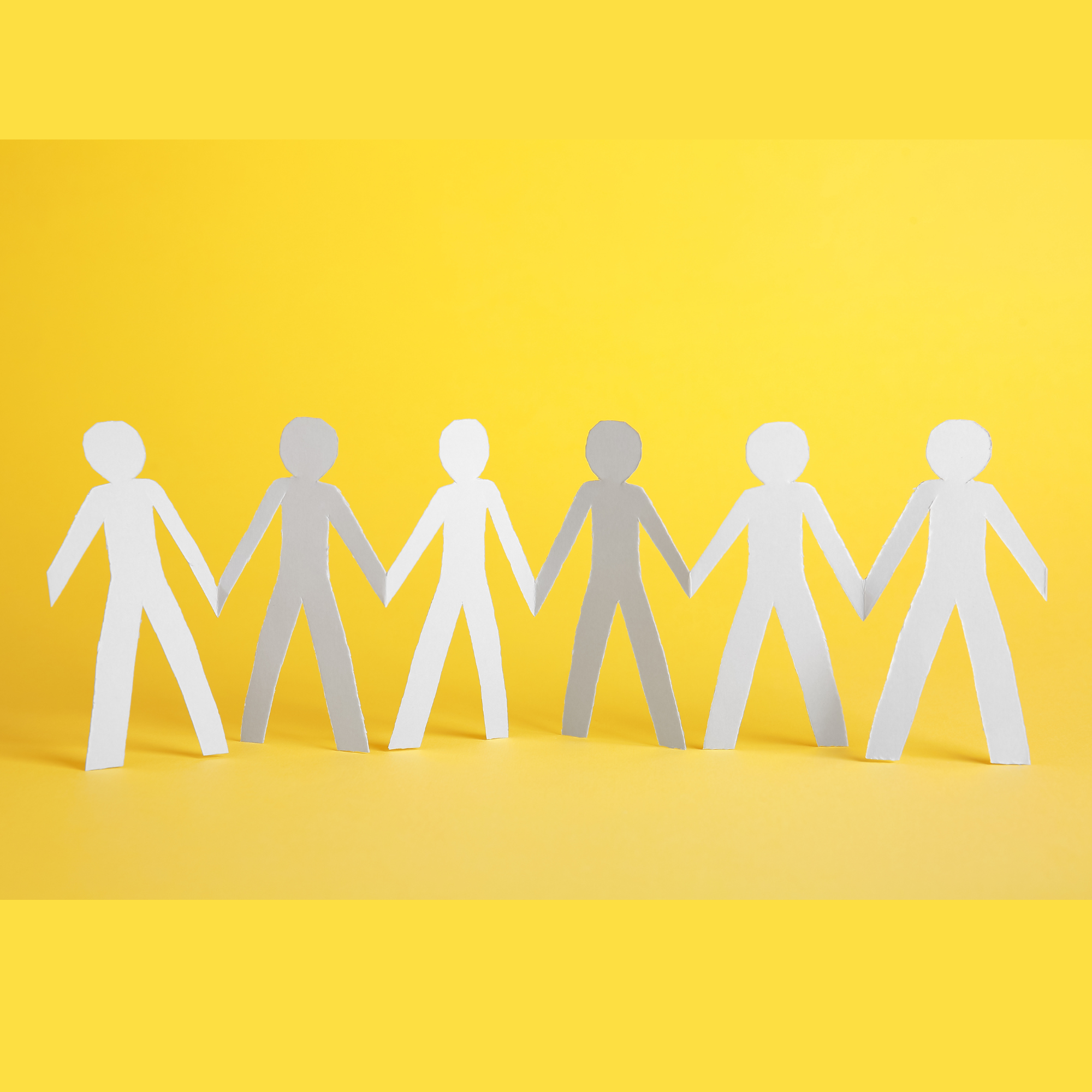 Paper chain of people on yellow background