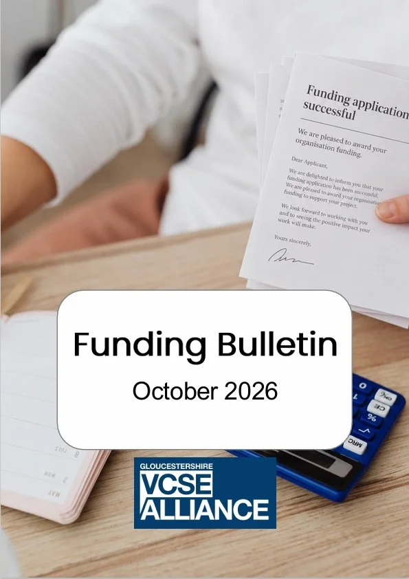 Front cover of the Funding Bulletin - October 2026 featuring a person sitting at a desk with a calculator and a pile of successful funding applications