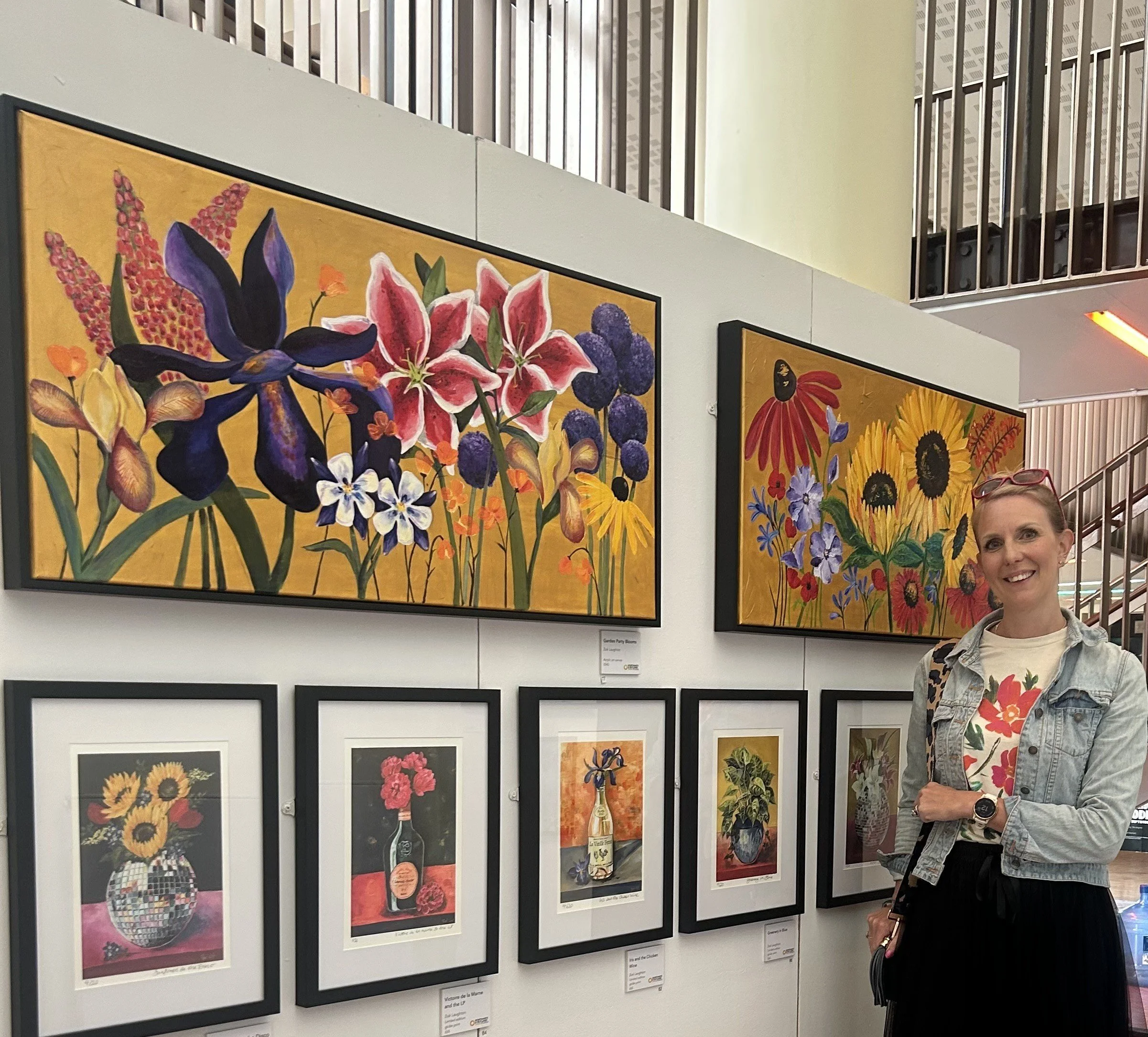Zoe Laughton looking at her Disco ball with flowers art