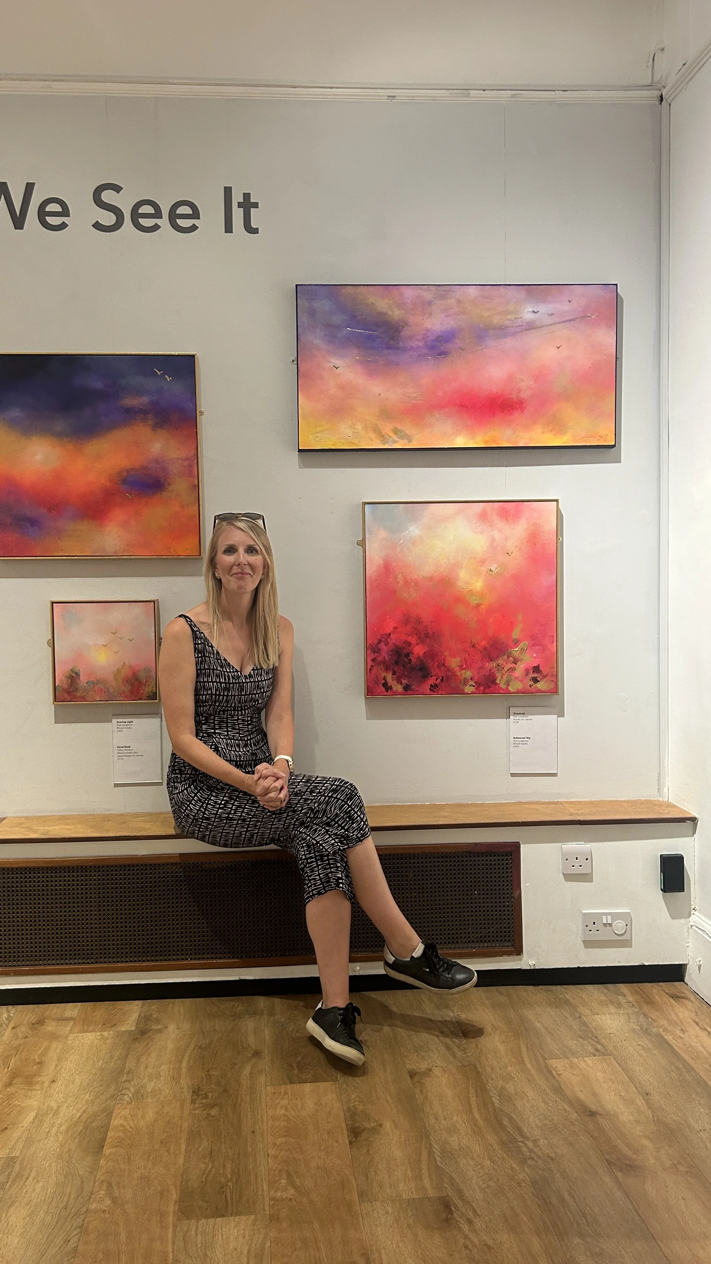 Zoe Laughton looking at her Disco ball with flowers art