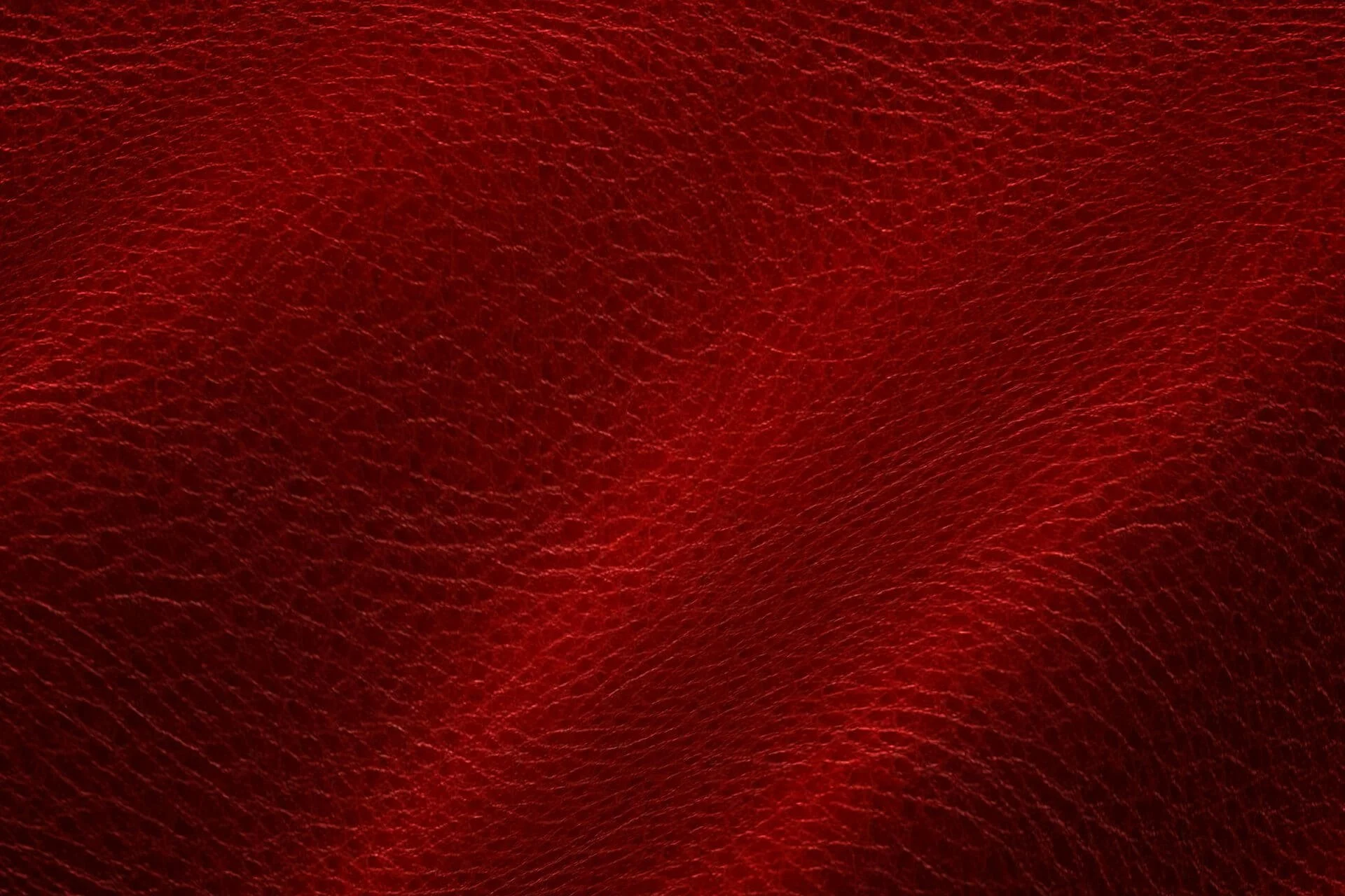 Close-up of red leather material with textured surface.