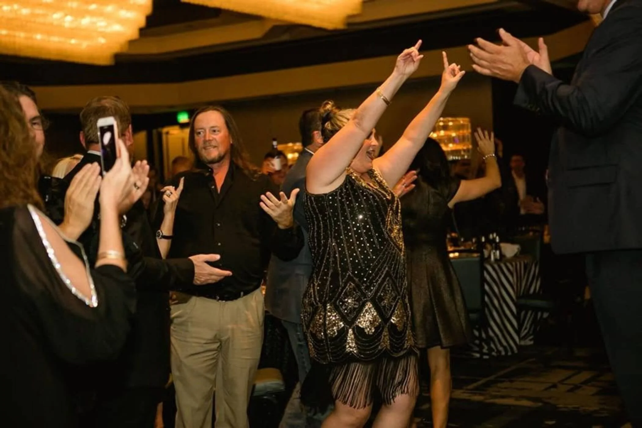 People dancing and enjoying themselves at a social event or party.