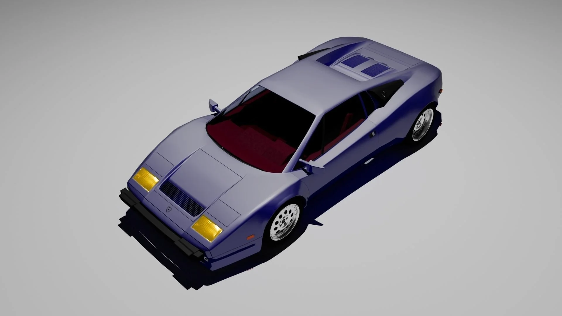 A blue, classic sports car with a low profile, tinted windows, and aerodynamic design on a plain background.