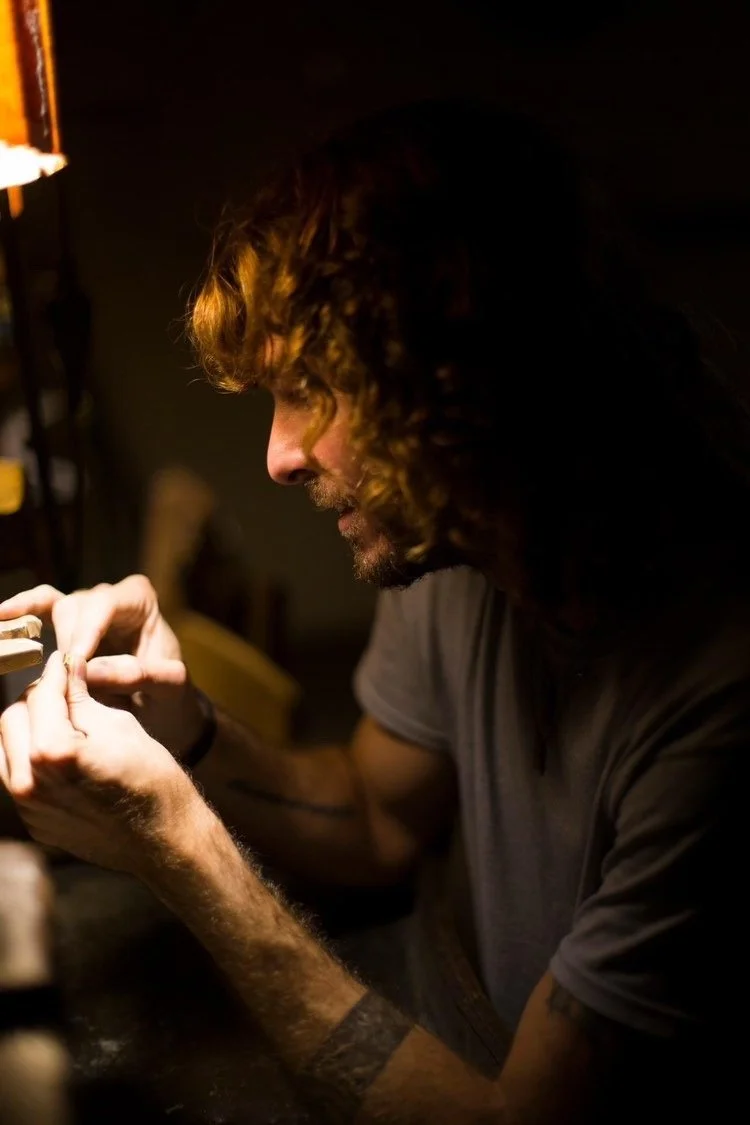 Facundo Harvey working on a ring under a lamp