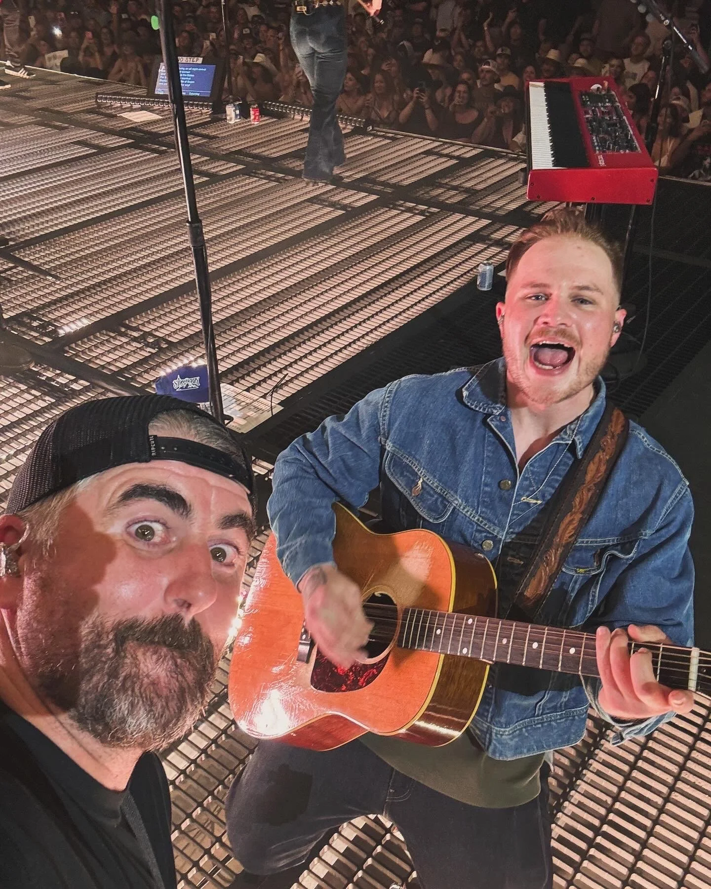 Fischtank and Zach Bryan taking a selfie onstage during Revival at his sold out show in Las Vegas.