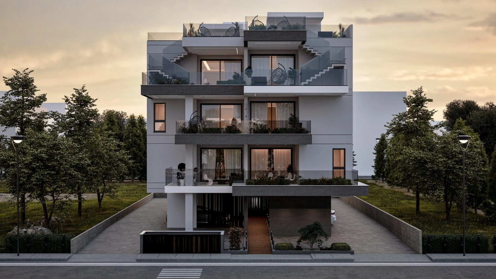 Modern four-story residential building with balconies, glass railings, and an entrance staircase, surrounded by trees and street lamps, at sunset. Greece, Investment, Golden Visa, Real Estate, Cyprus, Georgia, Lebanon, LPI, Athens.