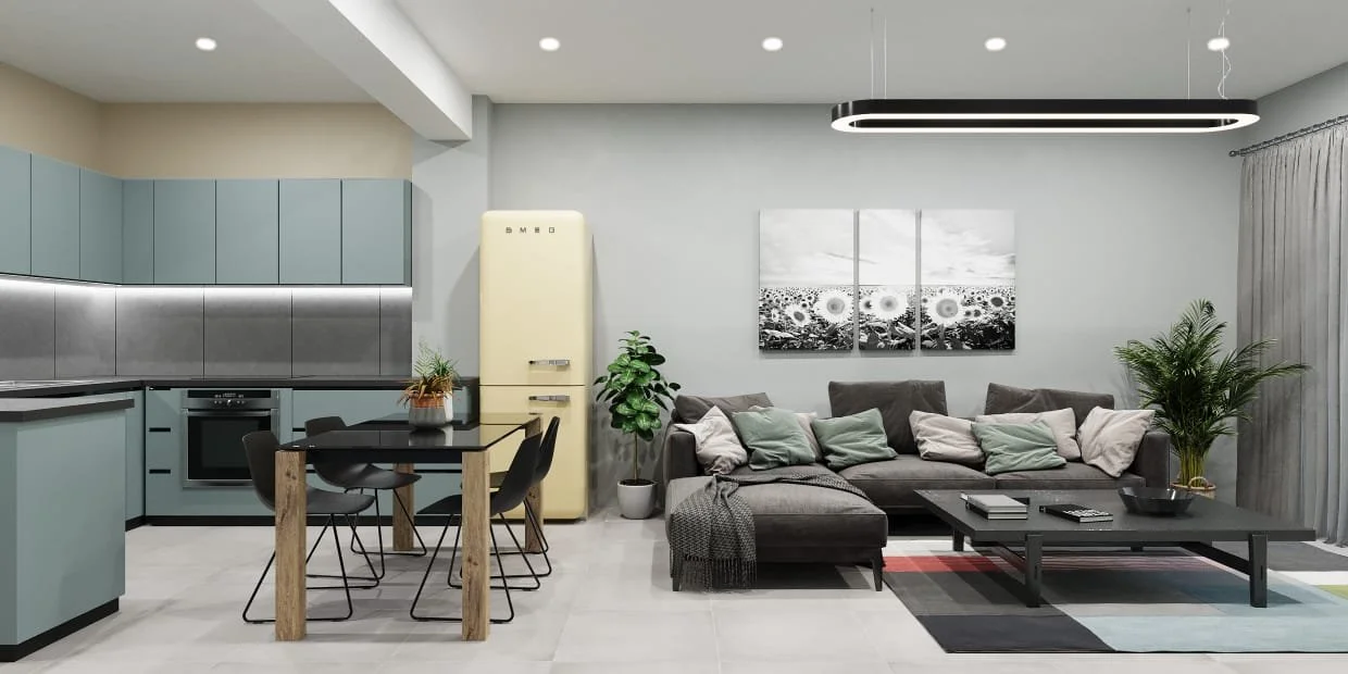 Modern living room and kitchen with gray sofa, black coffee table, yellow refrigerator, and light blue cabinets, decorated with plants and wall art.
