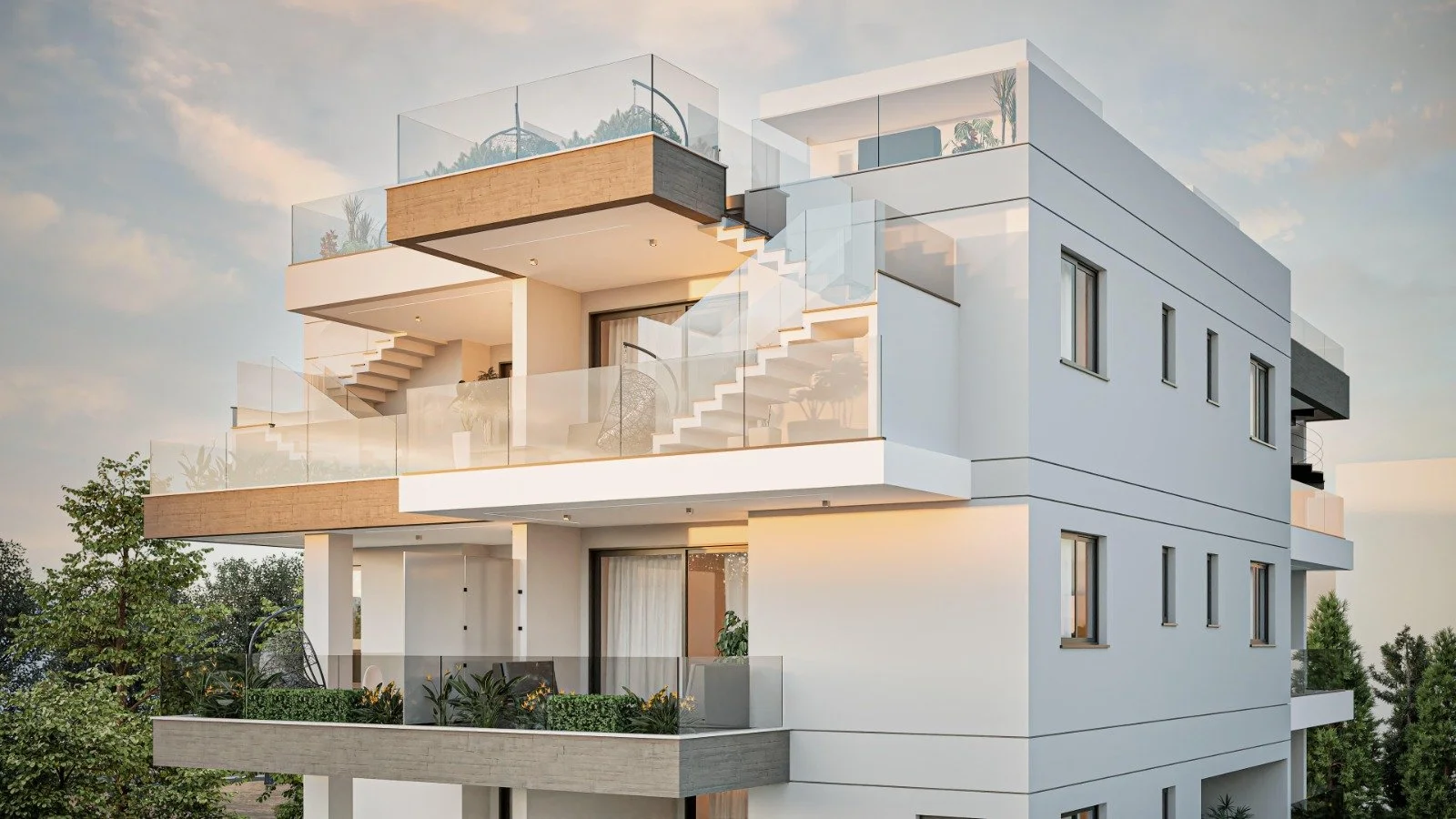 Modern white multi-story apartment building with balconies and glass railings, surrounded by greenery, under a partly cloudy sky. Greece, Investment, Golden Visa, Real Estate, Cyprus, Georgia, Lebanon, LPI, Athens.
