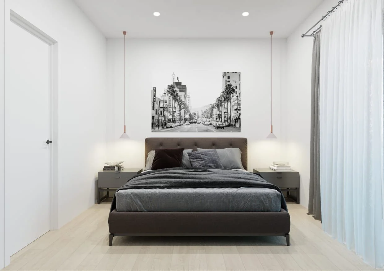 Modern bedroom with a bed, gray bedding, and pillows, two wall-mounted pendant lights, a black-and-white cityscape photo above the bed, nightstands with books and lamps, white walls, and curtains on the right side.