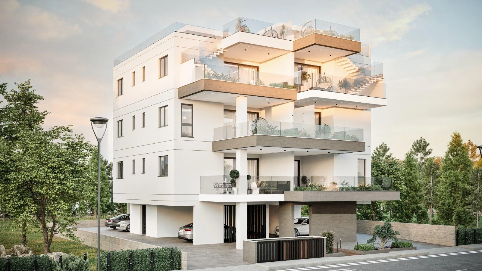 Modern multi-story apartment building with multiple balconies, glass railings, and outdoor furniture, surrounded by trees and parked cars. Greece, Investment, Golden Visa, Real Estate, Cyprus, Georgia, Lebanon, LPI, Athens.