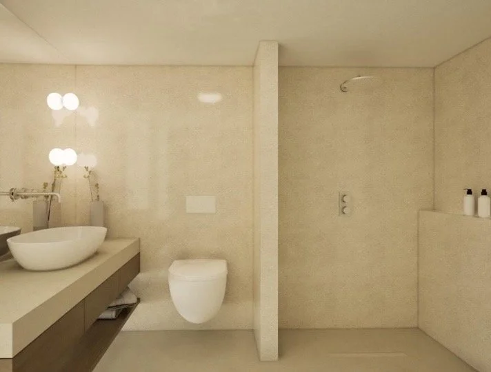 Modern bathroom with a beige color scheme, featuring a wall-mounted toilet, a floating vanity with a vessel sink, and a walk-in shower with two bottles on a ledge.