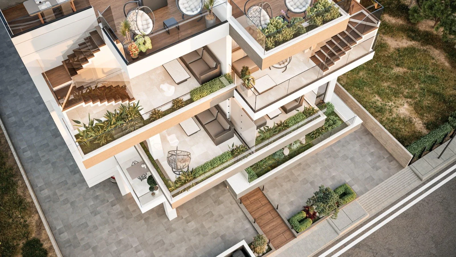 Aerial view of a modern, multi-story residential building with outdoor balconies featuring outdoor furniture, potted plants, and greenery. The building is next to a paved area and a grassy yard. Greece, Investment, Golden Visa, Real Estate, Cyprus, G