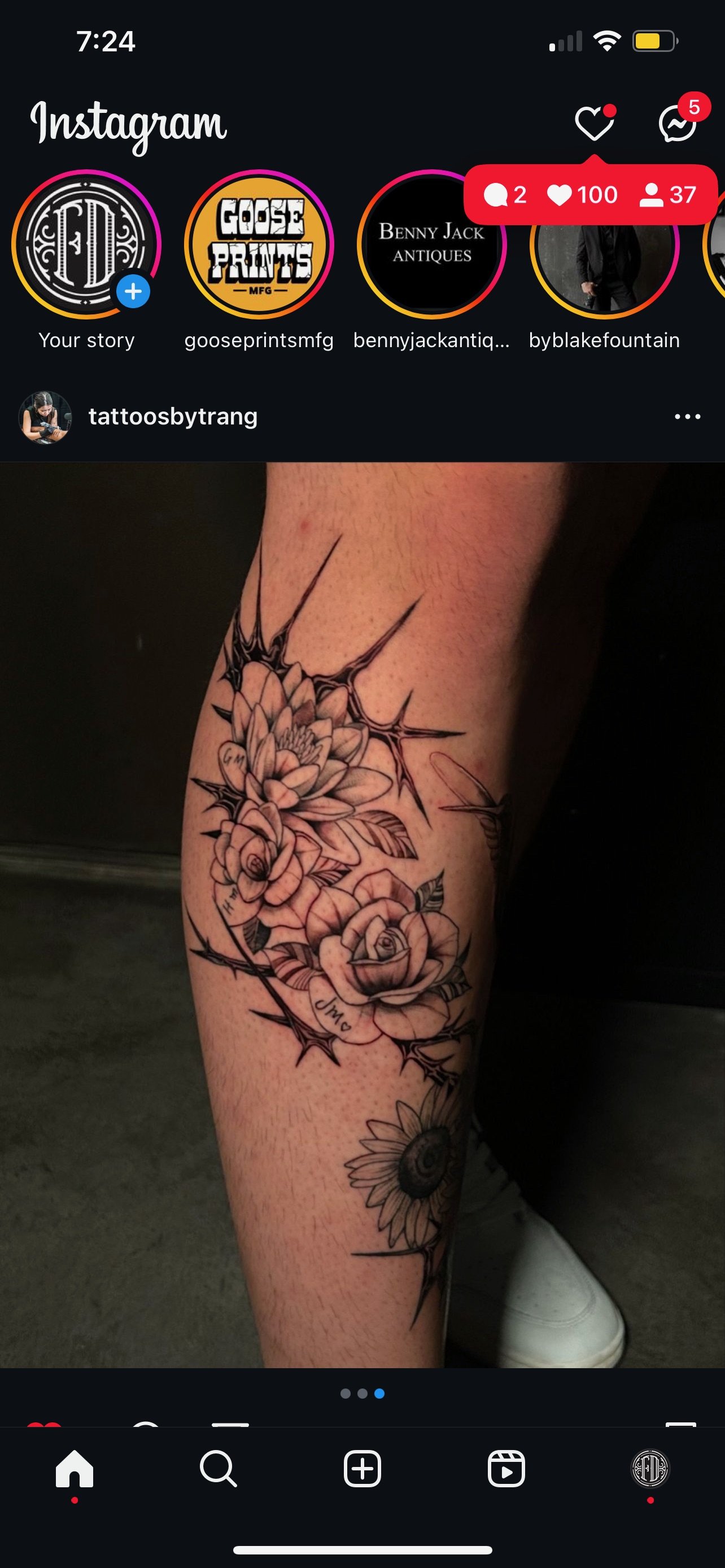 A tattoo on a person's leg featuring detailed black and gray roses, thorns, and a sunflower.