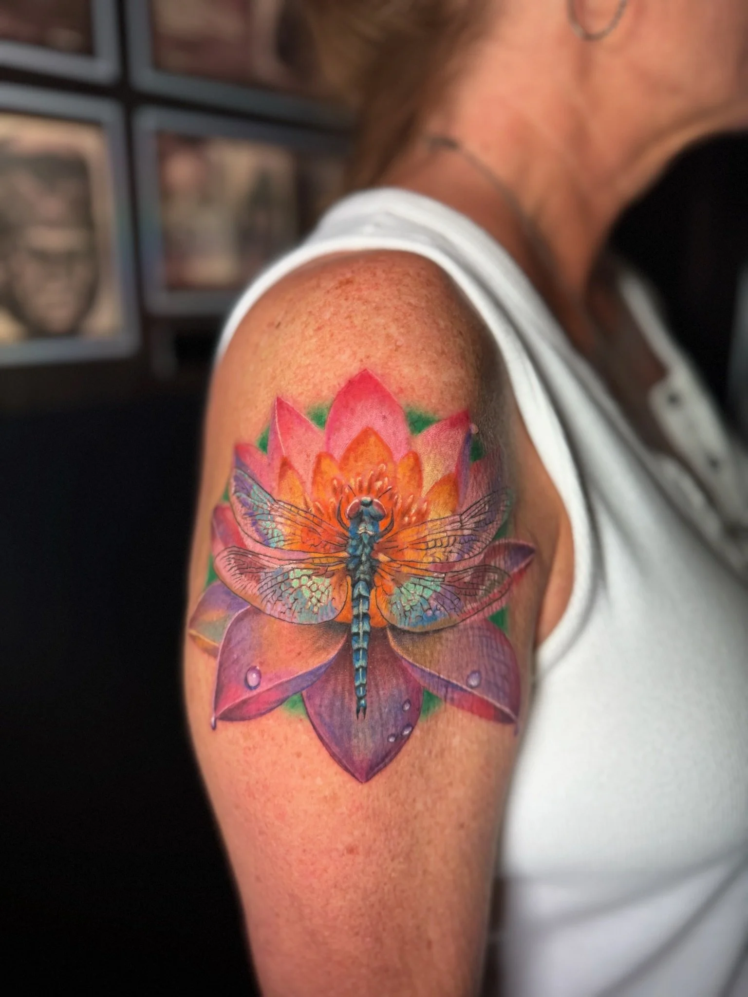 Colorful butterfly tattoo on person's upper arm, with intricate details and vibrant colors.