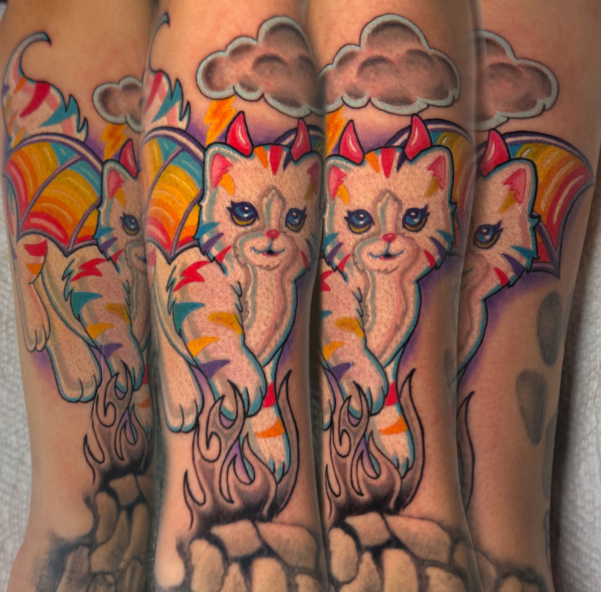 Colorful tattoo of a unicorn with a rainbow mane and clouds with lightning bolts.