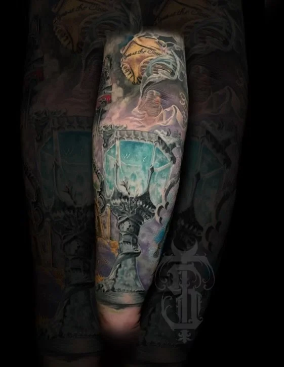 Colorful tattoo of a trophy cup on a person's leg.
