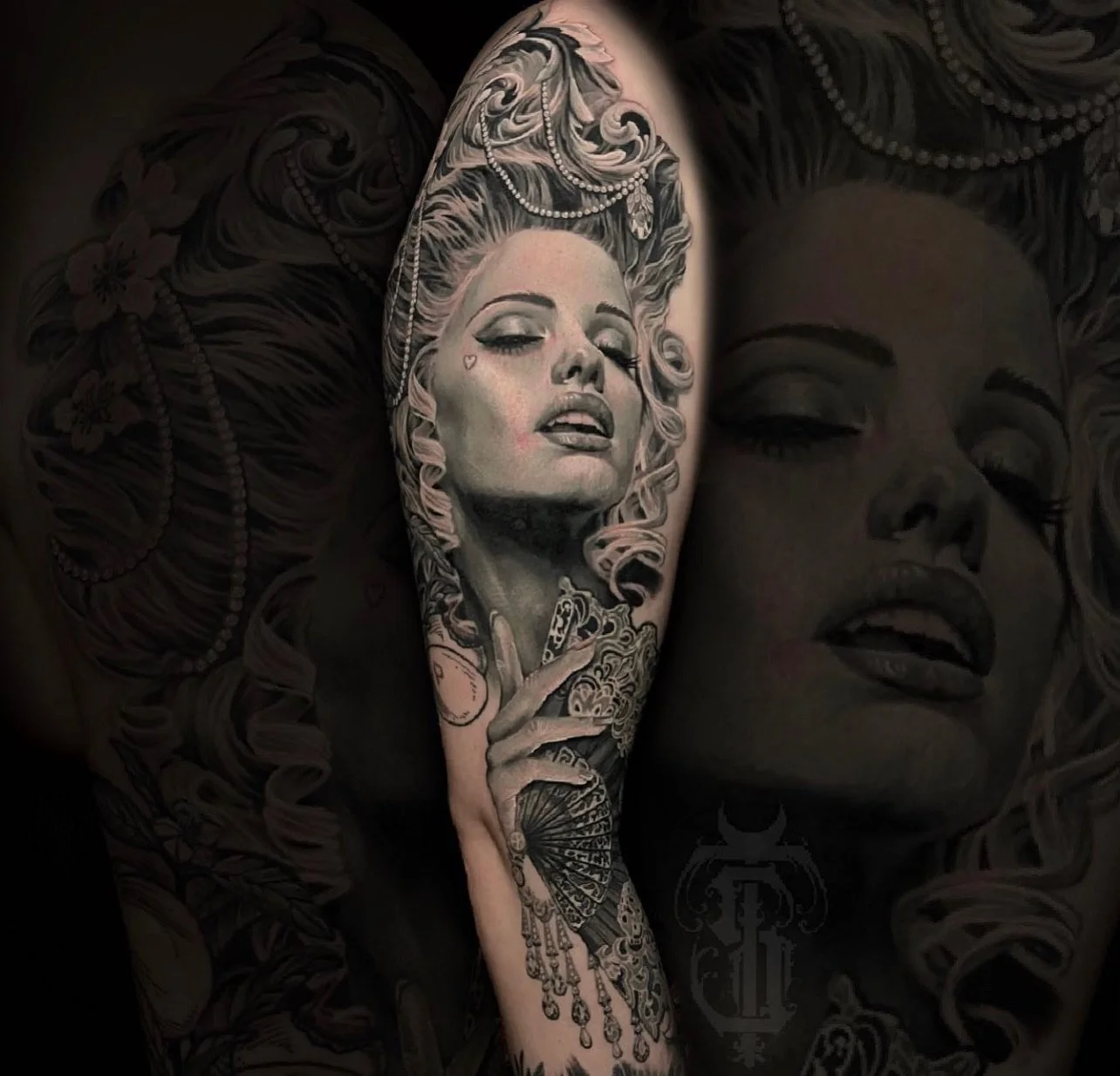 Tattoo of a woman with blond hair and jewelry, holding a fan, on a person's arm. The person's skin has a large tattoo of the same woman with closed eyes, as part of a full-arm tattoo design.