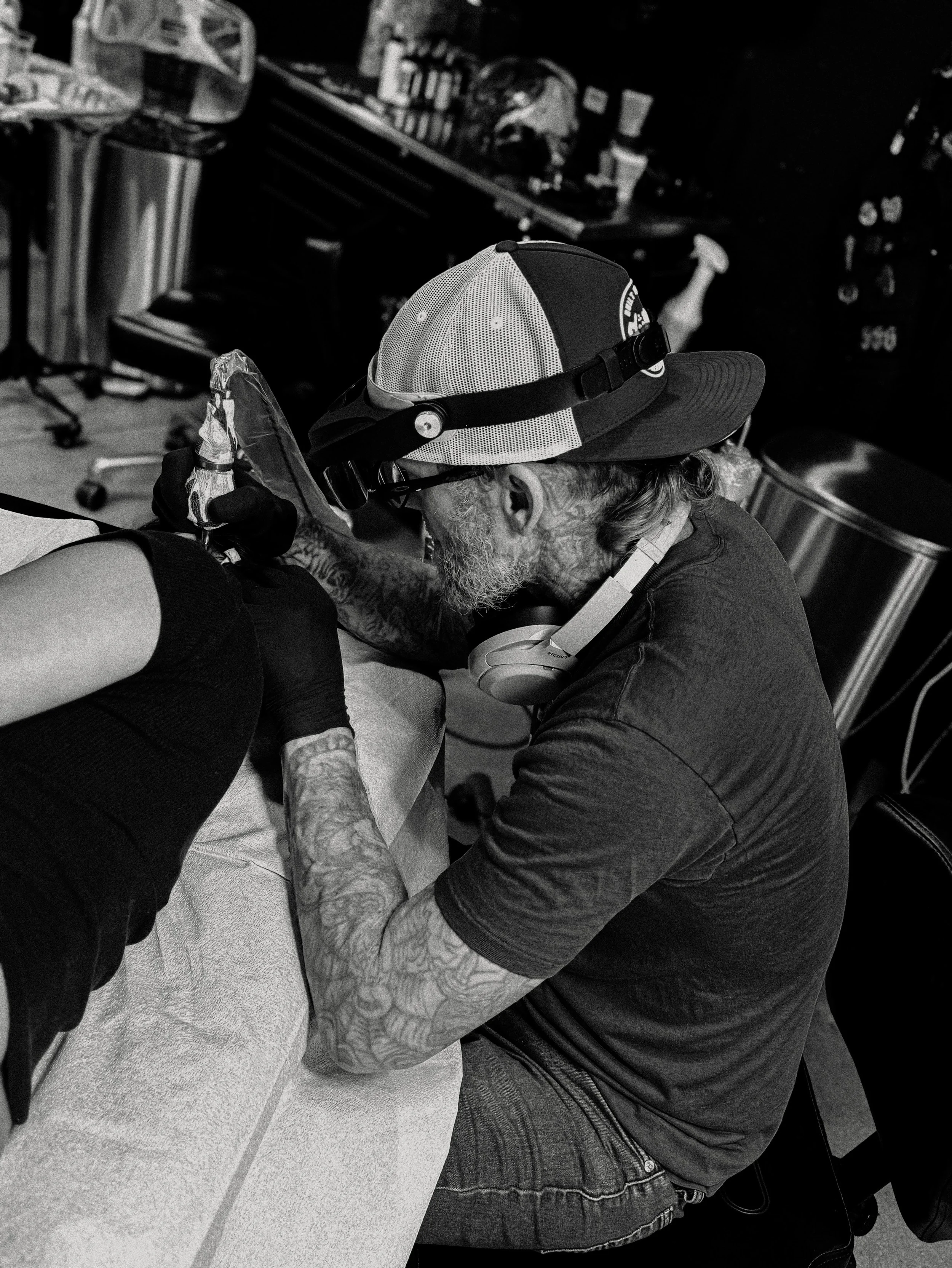 side angle photo of a man tattoo a womans  neck