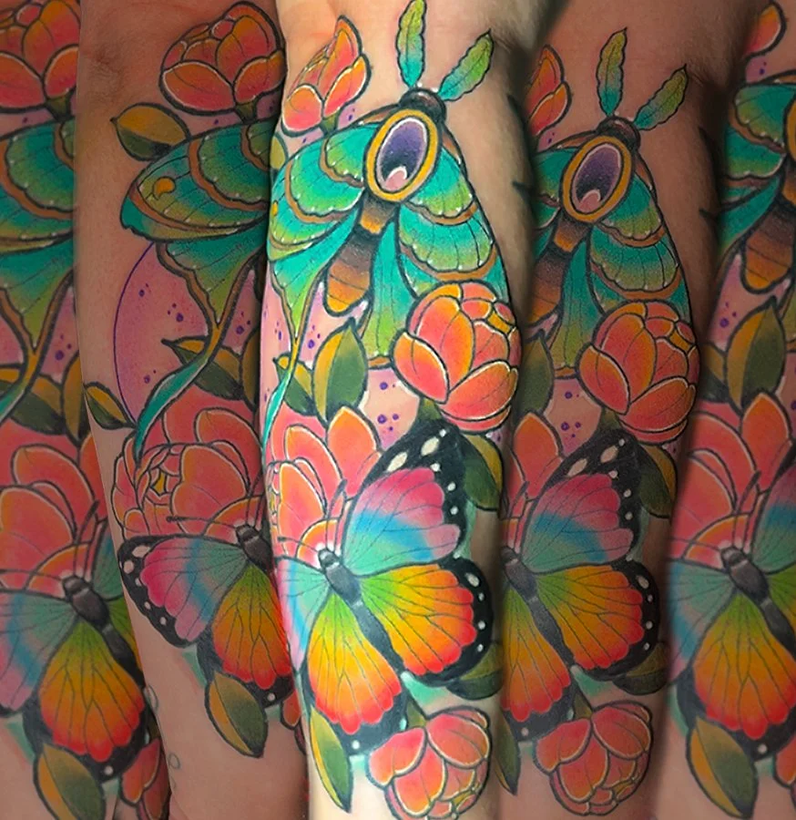 Colorful tattoo of butterflies and flowers on skin.