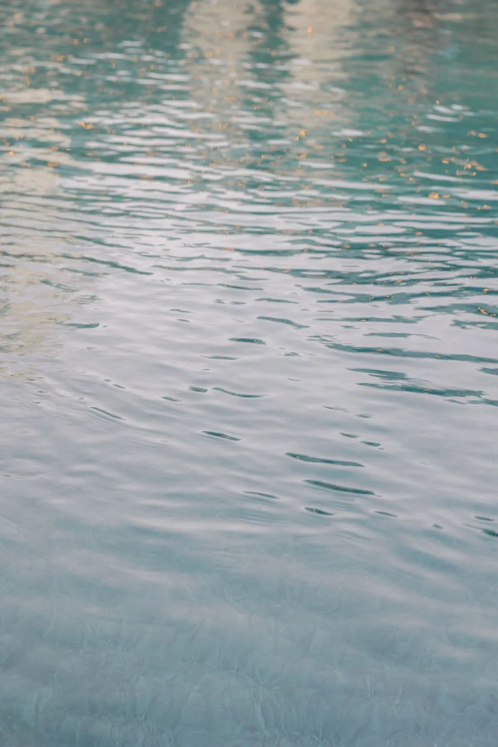 Close-up of rippling water in a body of water, possibly a lake or pond, with subtle reflections and a peaceful atmosphere.