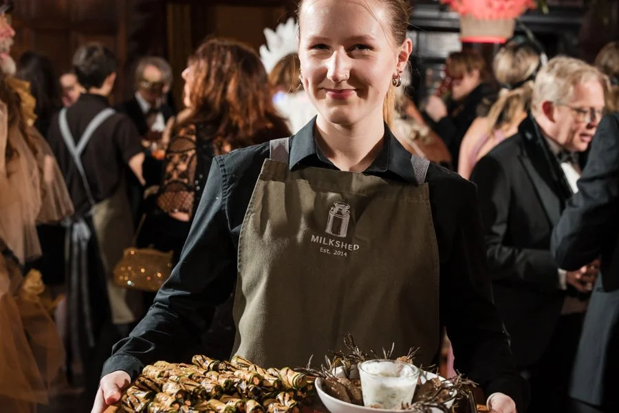 Waitress handing out delicious canapes during a corporate event in Exeter.
