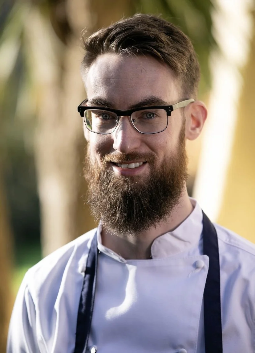 Pastry chef smiling ready for service.